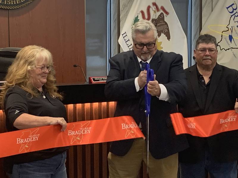 Bradley Mayor Mike Watson cuts the ribbon to reopen the renovated Bradley Village Board room on Monday, Aug. 25, 2025.