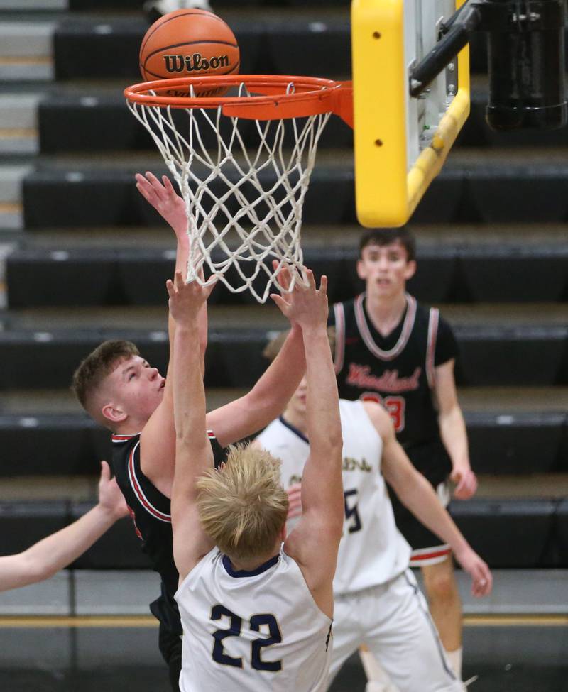Woodland's Jon Moore eyes the hoop over Marquette's Henry McGrath during the Tri-County Conference Tournament on Thursday, Jan. 25, 2024 at Putnam County High School.