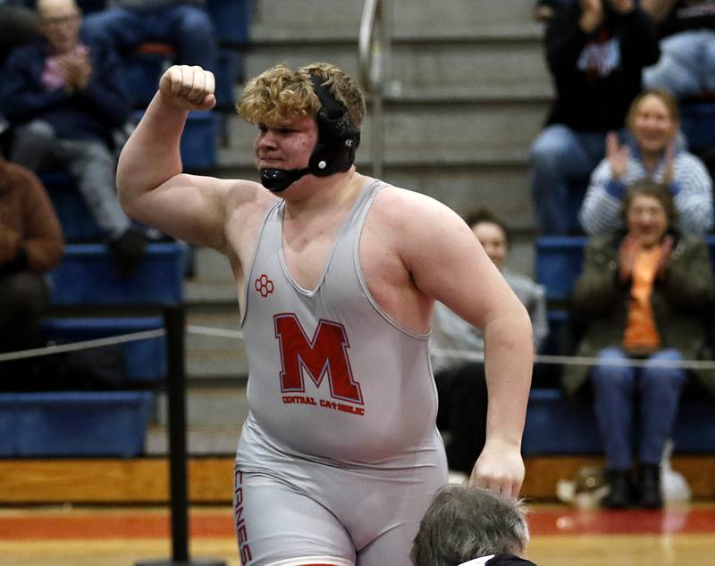 Marian Central's Kaleb Eckman celebrates pinning Mt. Carmel's David Ajayi in their 285-pound match during a triangle wrestling meet on Saturday Jan. 11, 2025, between Marian Central, Joliet Catholic, and Mt. Carmel at Marian Central High School in Woodstock.