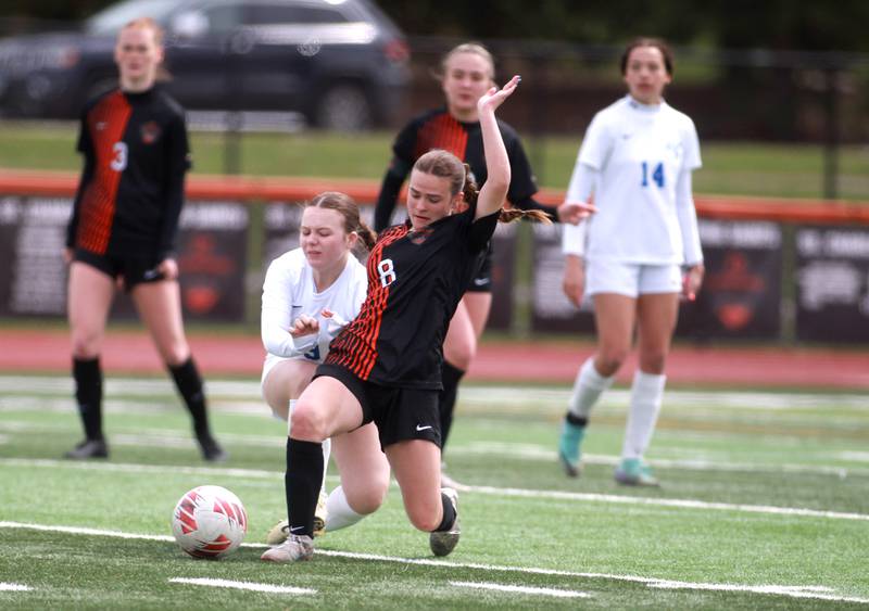 St. Charles East’s Georgia Smith (right) gets the ball away from Burlington Central’s Carmie Winkelhake during a game on Tuesday, April 1, 2025 in St. Charles.
