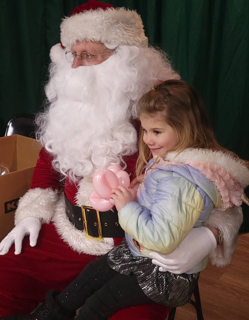 Four-year-old Chanel Shepard, of Ohio, enjoys her visit with Santa Claus during Saturday's Ladd Christmas Parade festivities.