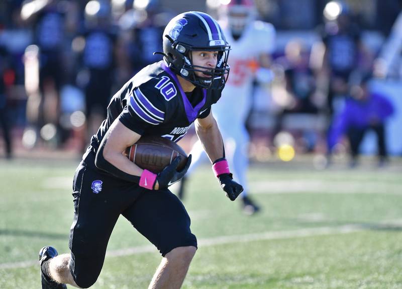 Downers Grove North's Oliver Thulin breaks for the end zone after catching a long pass from quarterback Owen Lansu during an IHSA Class 7A semifinal game on Nov. 18, 2023 at Downers Grove North High School in Downers Grove .