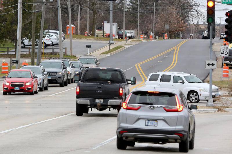 Vehicles travel to their destinations by way of the intersection of Lake Avenue and Route 47 on Monday, Nov. 30, 2020, in Woodstock. The intersection will become a roundabout as part of the Route 47 widening project.