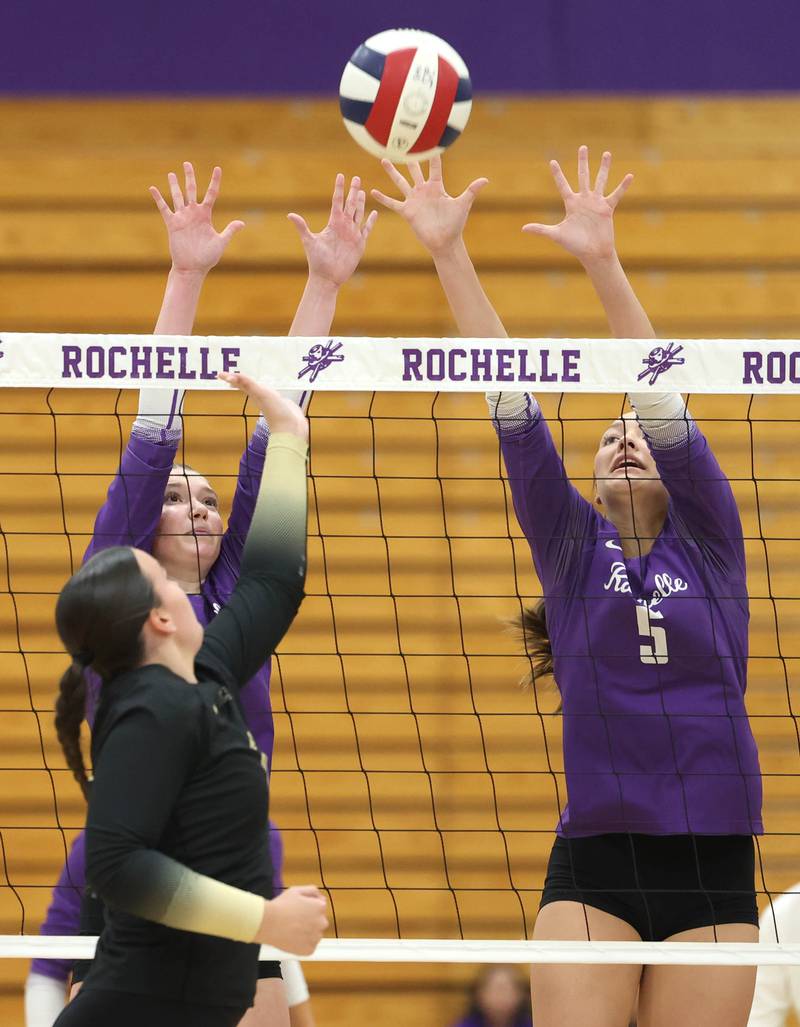 Rochelle's Jaydin Dickey (left) and Audyn Kemp try to block the tip of Sycamore's Sophia Lichthardt Tuesday, Oct. 28, 2025, during their Class 3A regional semifinal match at Rochelle High School.