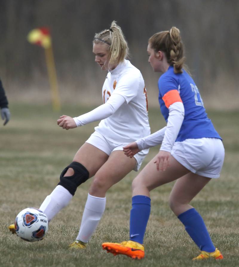 Richmond-Burton's Jordan Otto takes passes the ball as she is defended by Woodstock's Reese Freund during a Kishwaukee River Conference soccer match Wednesday, April 30, 2022, between Richmond-Burton and Woodstock at Creekside Middle School.