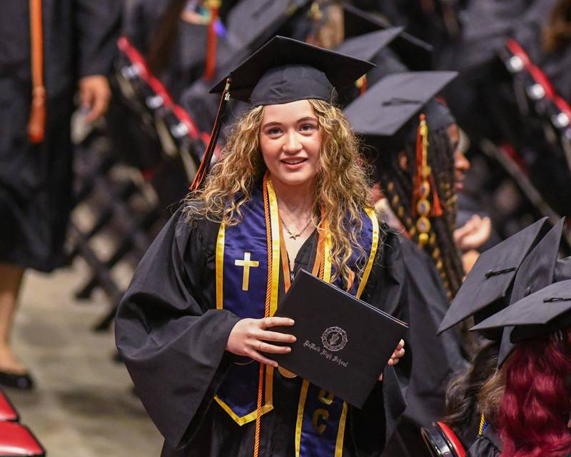 A DeKalb High School graduate is all smiles as she walks back to her seat after accepting her diploma during the graduation ceremony on Saturday May 23, 2026, held at the Convocation Center in DeKalb.