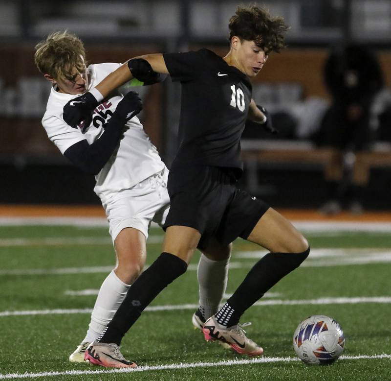 McHenry's Marko Stojich (right) tries to keep Prairie Ridge's Jensen Schroeder from the ball during a Fox Valley Conference soccer match on Tuesday, Oct. 15, 2024, at McCraken Field in McHenry.