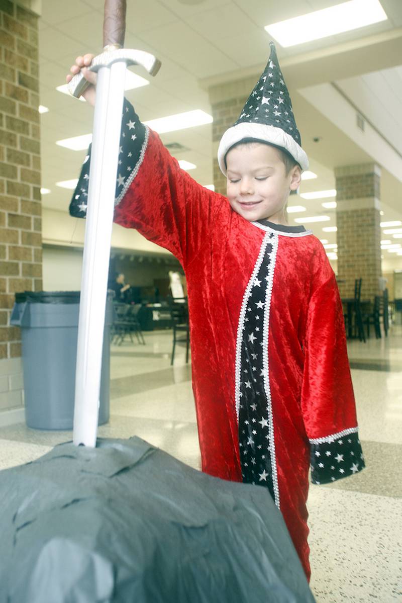 Henry Vanderbleek, 4, of DeKalb, pulls the sword out of the stone at DeKalb Public Library's Fantasy Fest on Oct. 4.