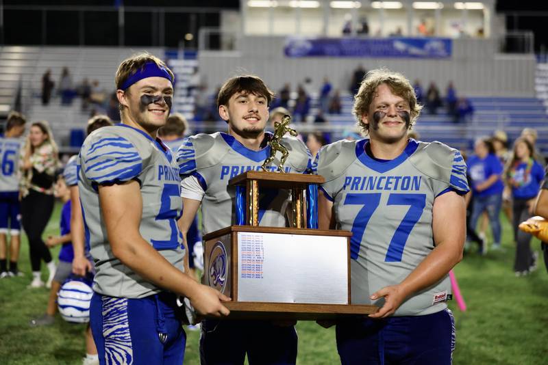 Princeton Tigers hoist the spoils of victory after their 63-12 win over Kewanee on Friday.