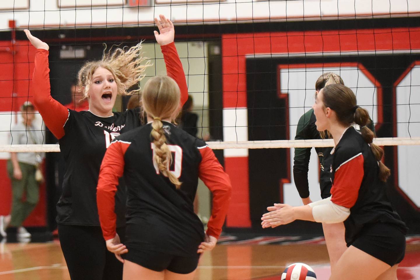 Bradley-Bourbonnais' Elena Shold, left, celebrates a point with Boilermaker teammates Harper Tollefson (10) and Ella Haas during their 2-0 home All-City win over Bishop McNamara Wednesday, Sept. 10, 2025.