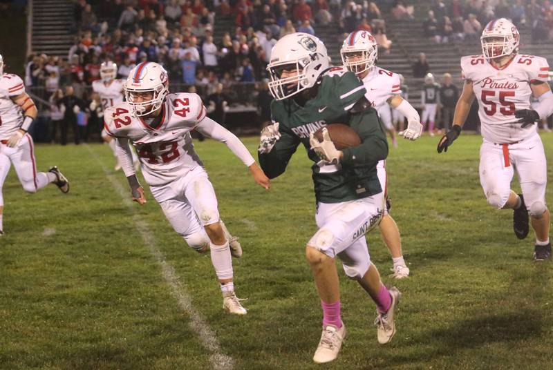 St. Bede's Carson Riva runs past Ottawa's Joey Liebhart Weston Averkamp and Evan Paris on Friday, Oct. 25, 2024 at St. Bede Academy.