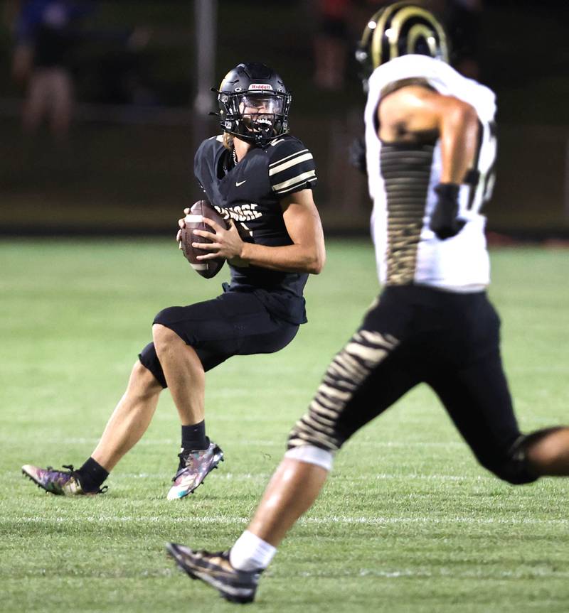Sycamore's Elijah Meier looks for a receiver in the Oak Forest secondary during their game Friday Sept. 2, 2022, at Sycamore High School.