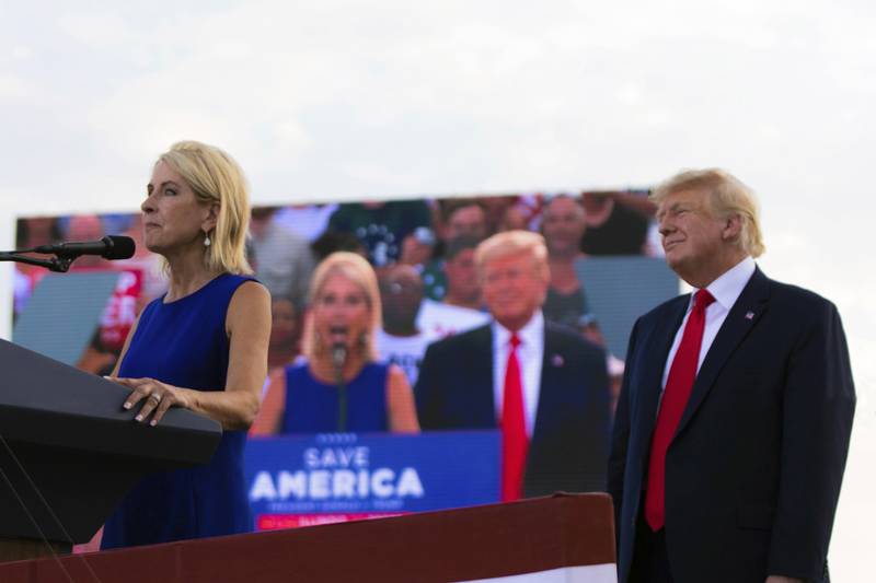 Republican U.S. Rep. Mary Miller, of Illinois, speaks as former President Donald Trump stands behind her on stage at a rally at the Adams County Fairgrounds in Mendon, Ill., Saturday, June 25, 2022. (Mike Sorensen/Quincy Herald-Whig via AP)