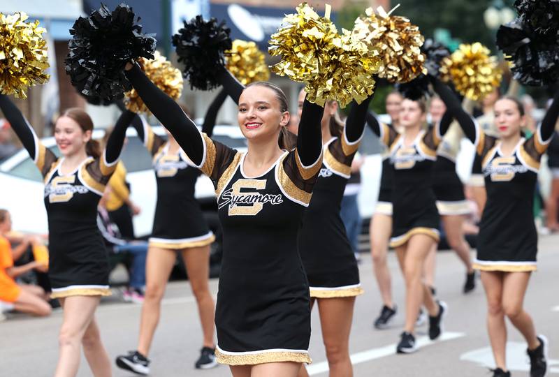 Members of the Sycamore High School dance team and cheerleaders head down State Street Wednesday, Sept. 20, 2023, during the Sycamore High School homecoming parade.