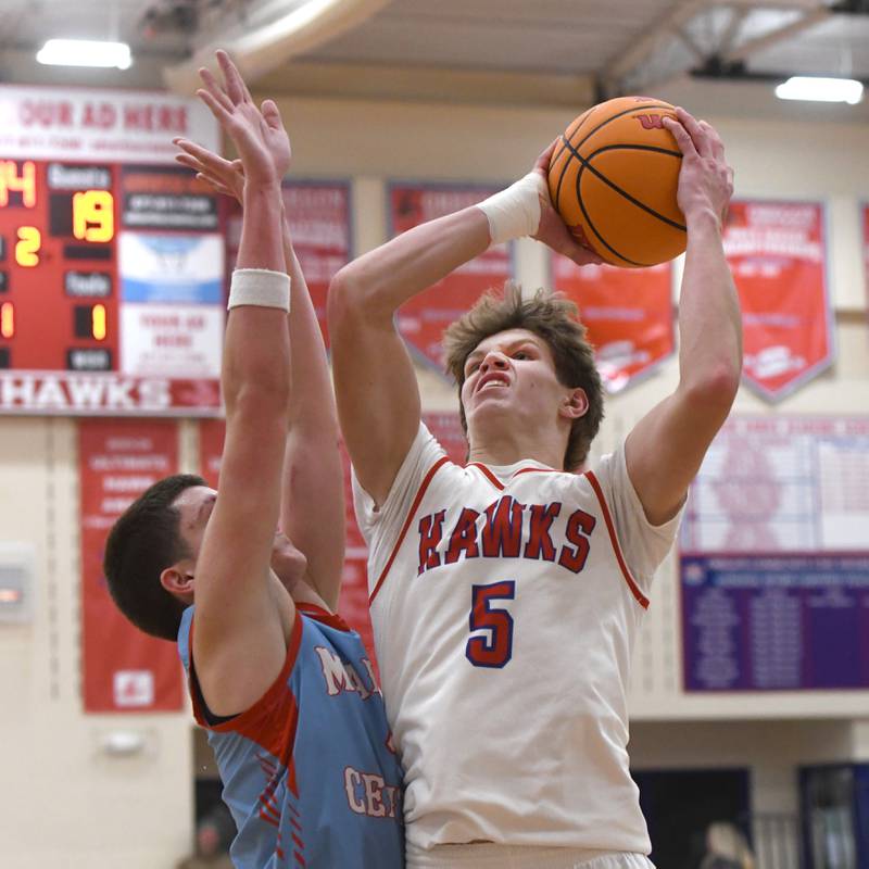 Oregon's Tucker O'Brien puts up a shot over a Woodstock Marian defender at the Oregon Boys Basketball Thanksgiving Tournament on Wednesday, Nov. 26, 2025 at the Blackhawk Center in Oregon.