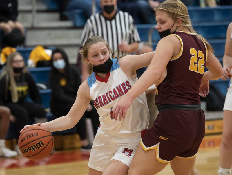 Marian Central's Abbey Miner (left) pushes past Richmond-Burton defender Zoe Hannemann (right)