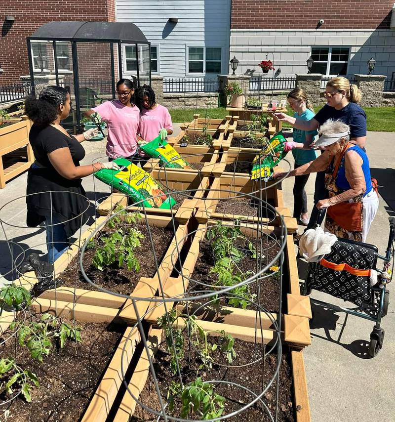 Girls Scouts work on the garden.