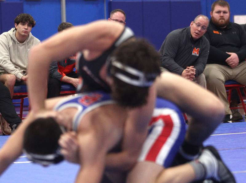 McHenry’s head coach Dan Rohman watches McHenry’s Aiden Fischler battle Dundee-Crown’s Jose Gavina at 160 pounds in varsity wrestling at Carpentersville Thursday night.