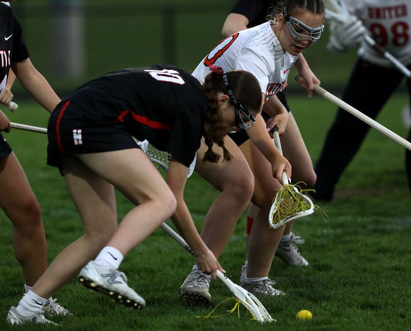 Huntley's Aubrie Salazar battles with Crystal Lake Central co-op's Lyla Meyers for the ball during a Fox Valley Conference girls lacrosse match on Friday, April 17, 2026, at Crystal Lake Central High School.