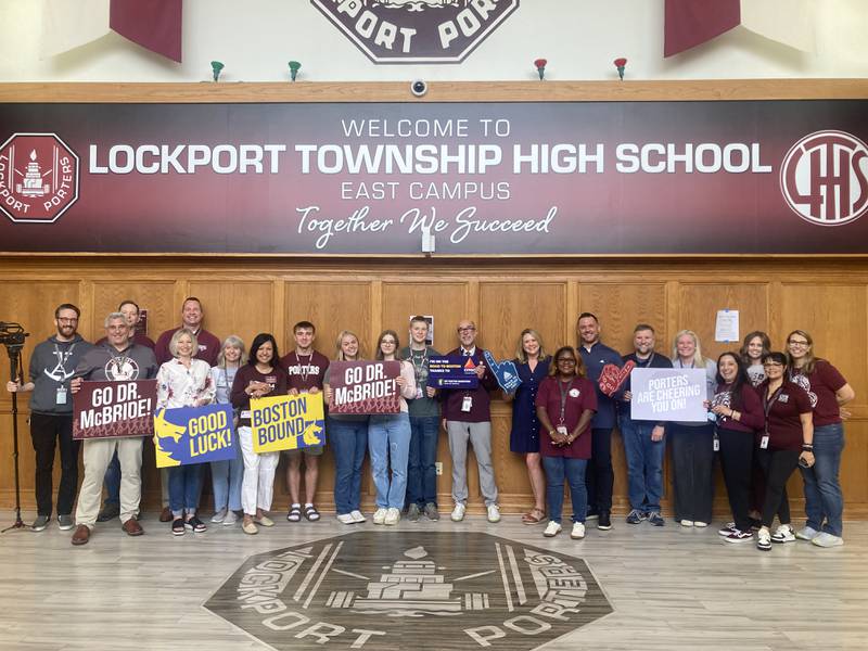 Lockport Township High School District administrators, teachers, staff, and board members stand with Dr. Robert McBride in the East Campus entry way on Friday, April 17, 2026.