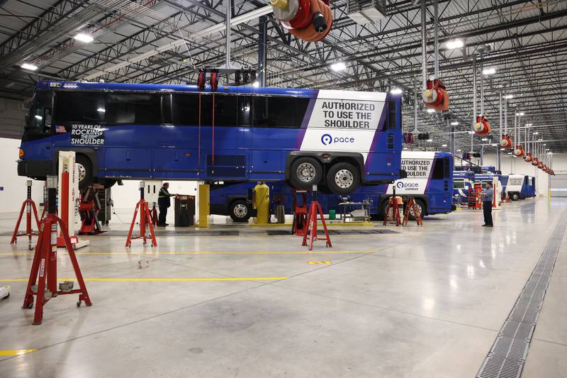 Multiple buses sit in the massive mechanics garage at the New Heritage Plainfield Facility.