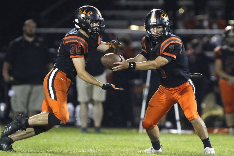 Crystal Lake Central quarterback Colton Madura hands the ball off to Brent Blitek during their football game against Crystal Lake South on Friday, Oct. 1, 2021 at Crystal Lake Central High School in Crystal Lake.