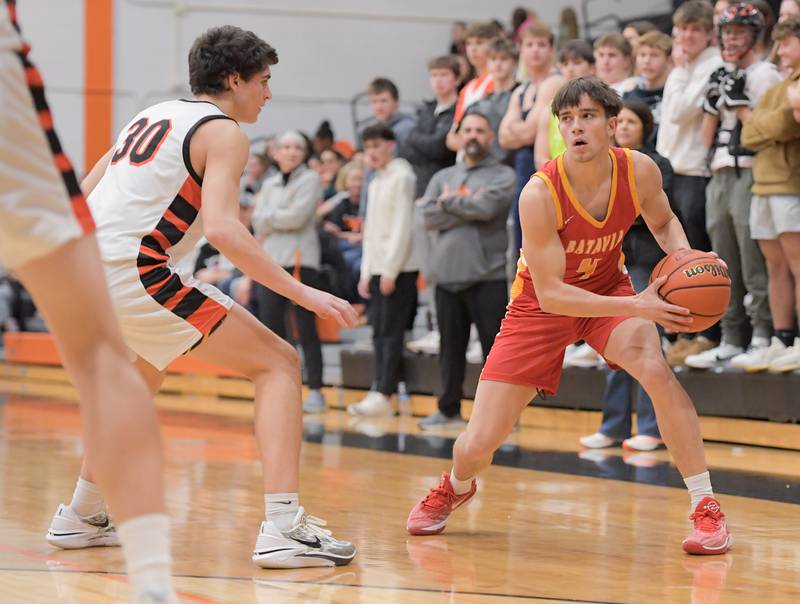 Batavia's Gavin Engelhart (4) looks to pass around Wheaton Warrenville South's Luca Carbonaro (30) during a game in Wheaton on Saturday, January 6, 2024.