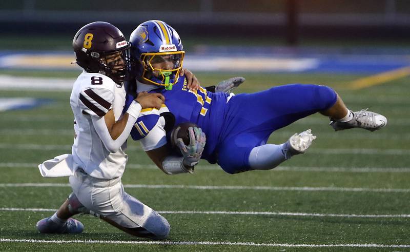 Richmond-Burton's Joseph Larsen tackles Johnsburg's Ryan Franze during a Kishwaukee River Conference football game on Friday, Sept. 12, 2025, at Johnsburg High School.