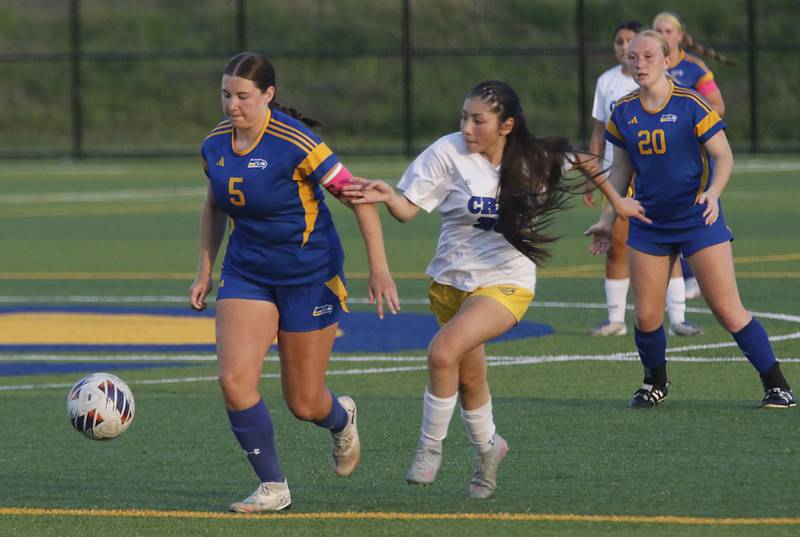 Johnsburg's Elaina Moss tries to get away from the defense of Cristo Rey St. Martin's Zaory Munoz during an IHSA Class 1A Cristo Rey St. Martin Sectional semifinal girls soccer match on Tuesday, May 26, 2026 at Cristo Rey St. Martin College Prep, in Waukegan.
