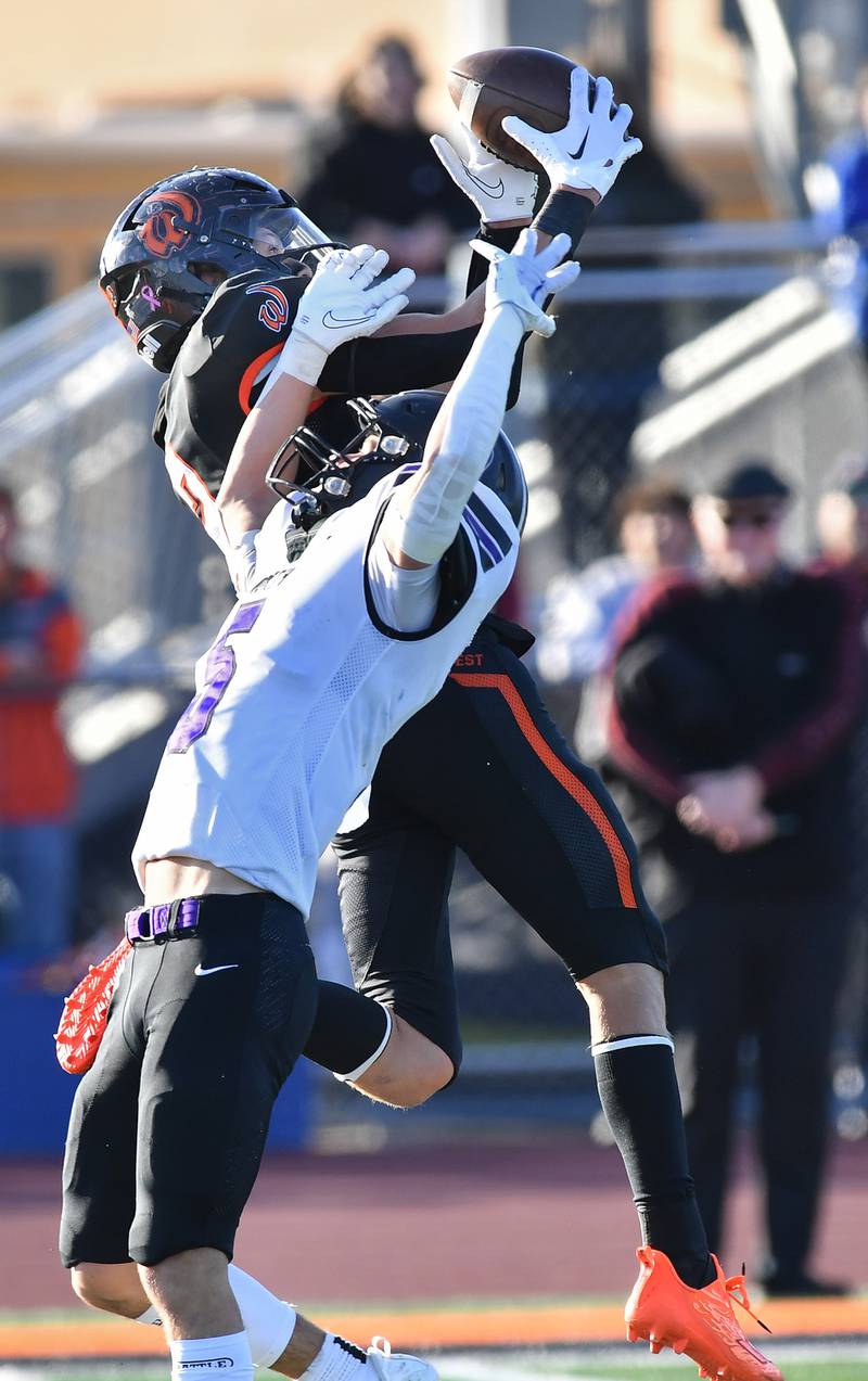 Lincoln-Way West's Braden Erwin (top) almost intercepts a pass intended for Downers Grove North's Owen Thulin during an IHSA Class 7A quarterfinal game on Nov. 11, 2023 at Lincoln-Way West High School in New Lenox.