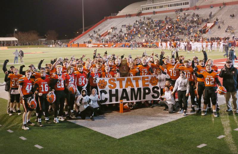 Members of the Byron football team pose for a photo with the Class 3A state championship trophy after defeating Mt. Carmel in the Class 3A State football championship on Friday, Nov, 24, 2023 at Hancock Stadium in Normal.
