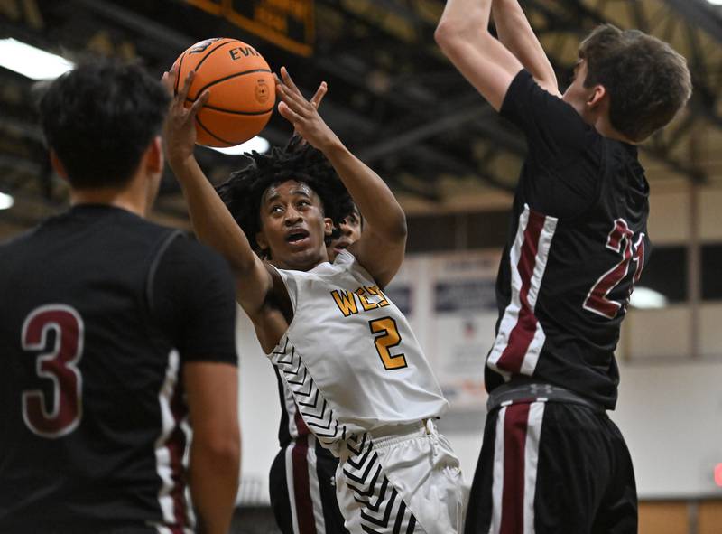 Joliet West's Nasir Sears (2) drives hard to the basket during a conference game against Plainfield North on Friday, Dec. 20, 2024, at Joliet.