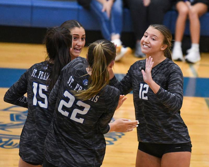 St. Francis's Jenna Glaudel (12) celebrates with teammates after scoring a point in the game while taking on St. Charles North held at St. Francis High School in Wheaton.
