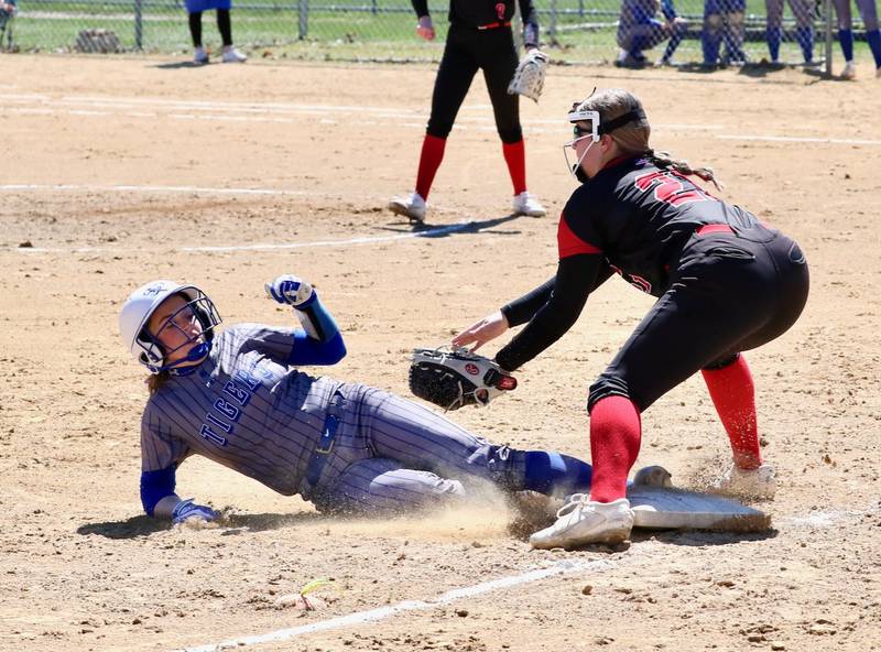 Princeton's Makayla Hecht slides in under the tag of Hall third baseman Ava Delphi for one of her seven steals Saturday in Spring Valley.