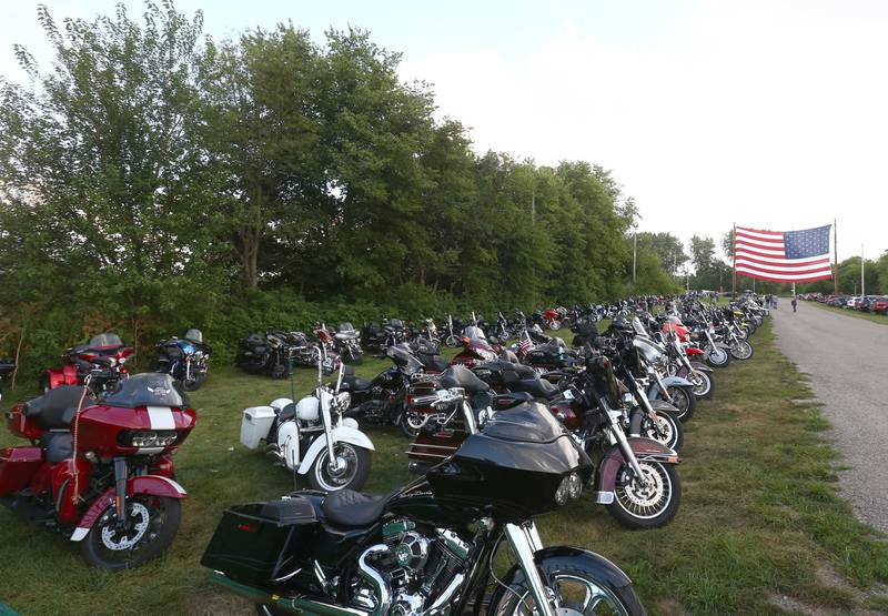Hundreds of motorcycles park underneath an American Flag for the Aaron Lewis concert at Psycho Silo Saloon on Thursday, Aug. 4, 2022 in Langley.