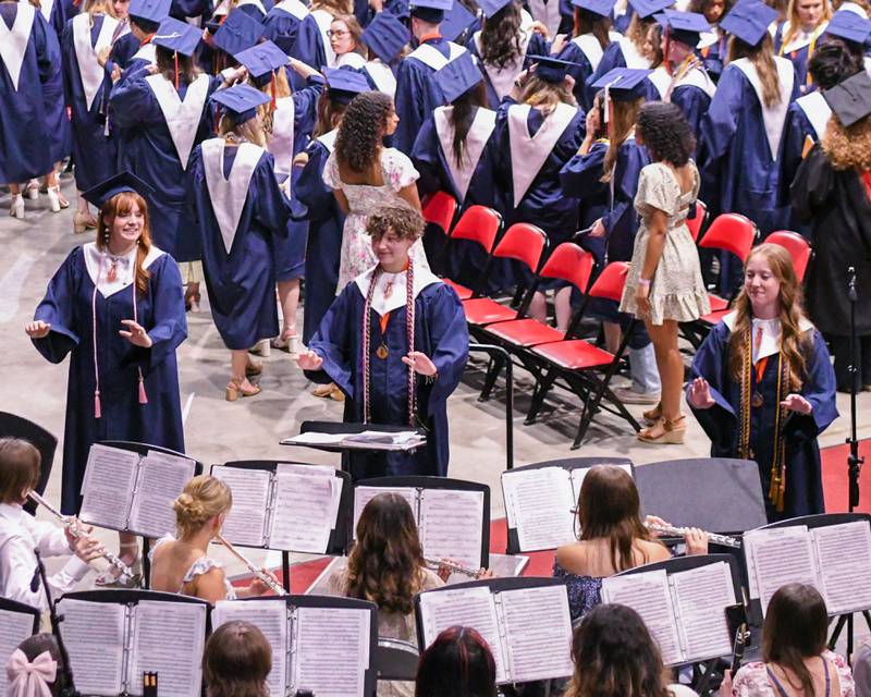 Oswego High School senior drum majors enjoy conducting one last song before leaving the graduation ceremony on Saturday May 17, 2025, held at the Convocation Center in DeKalb.