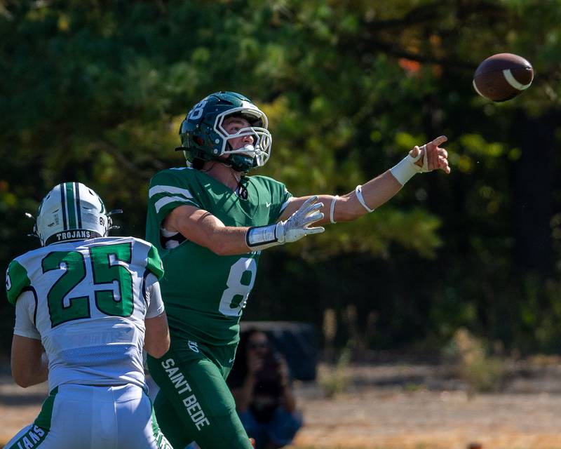 Gino Ferrari (8) of St. Bede throws pass as Ayden Collom (25) of Dwight tries to tackle on Saturday, Oct. 4, 2025 at Captain Thomas J. Heitmann field in Peru.