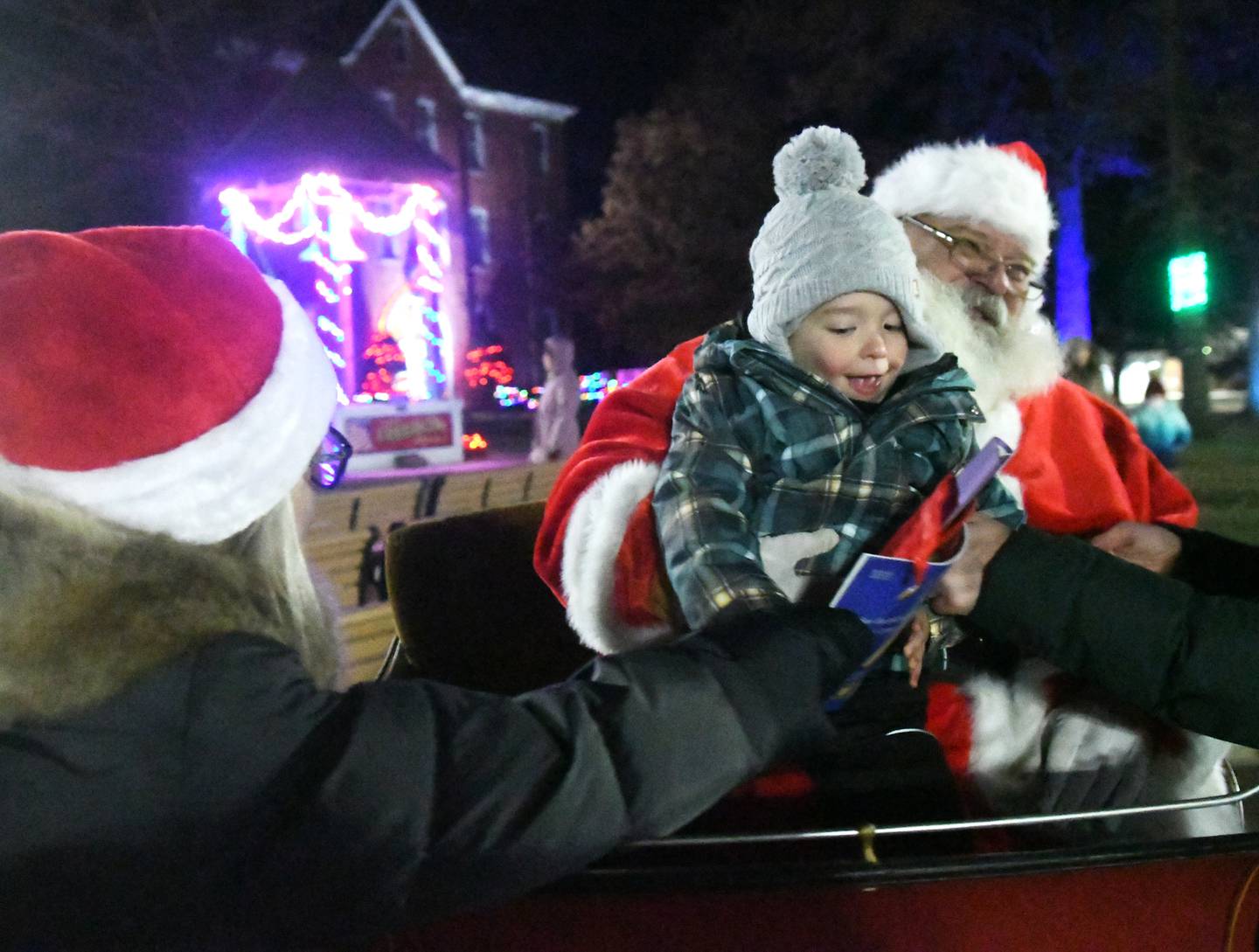 Harrison Taylor, 3, of Mt. Morris visits with Santa Claus at Mt. Morris' Festival of Lights on Dec.3. Harrison also received a free book from the Mt. Morris Library after he spoke with Santa.