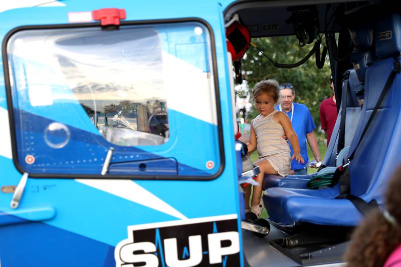 Addison Bastidas, 3, of Geneva sits in a Superior Air Med rescue helicopter during the Kane County Sheriff’s Office National Night Out event in St. Charles on Tuesday, Aug. 1, 2023. The community-building event began nationally in 1984.
