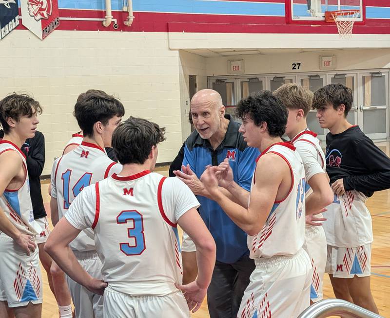 Marian Central first-year coach Rick Peterson talks to his players during a timeout Saturday, Dec. 14, against Cary-Grove in Woodstock.