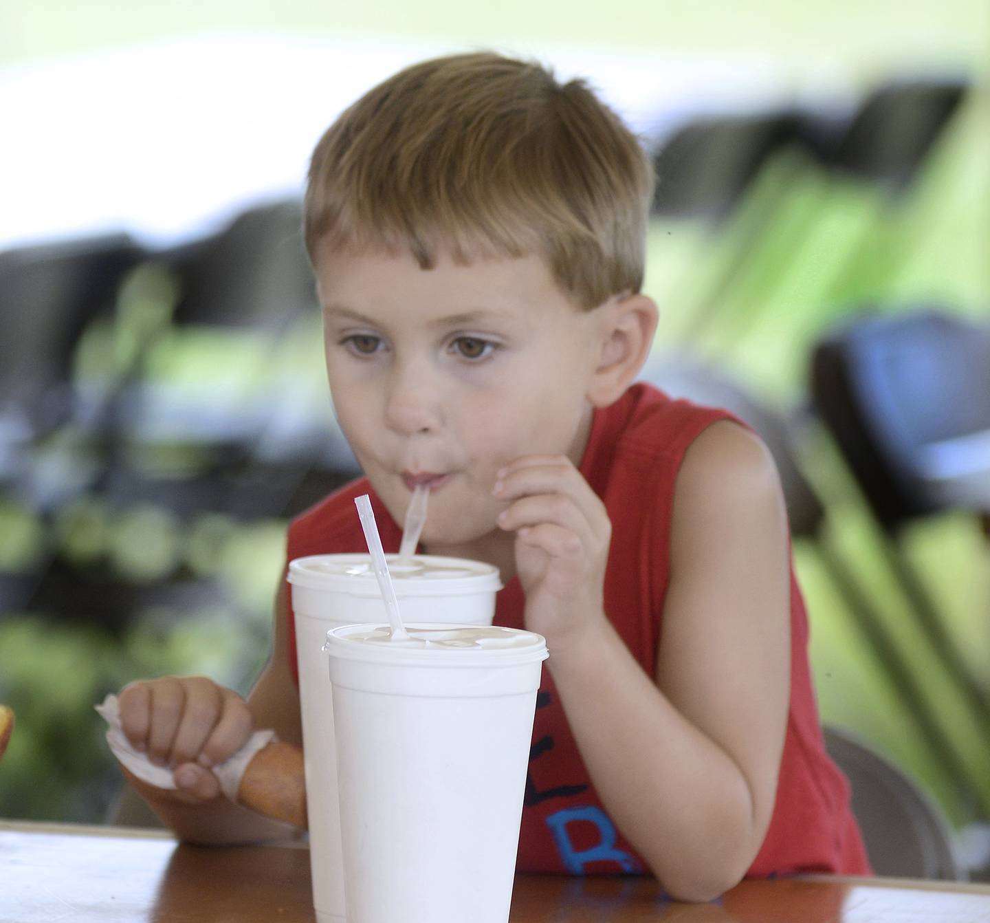 Kolsen McStoots enjoys a drink Wednesday, July 6, 2022, to go along with his corn dog during  Streator's 4th of July Celebration at Northpoint Plaza.