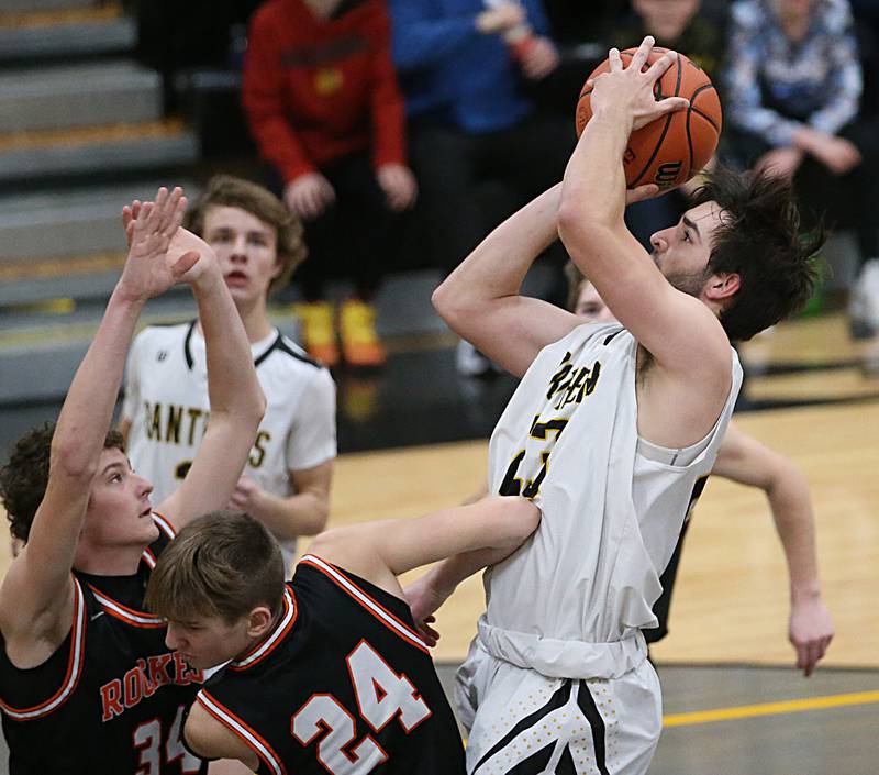 Putnam County's Jackson McDonald runs into the lane to shoot a jump shot over Roanoke-Benson's Jude Zeller and Jack Leman during the Tri-County Conference Tournament on Tuesday, Jan. 24, 2023 at Putnam County High School.
