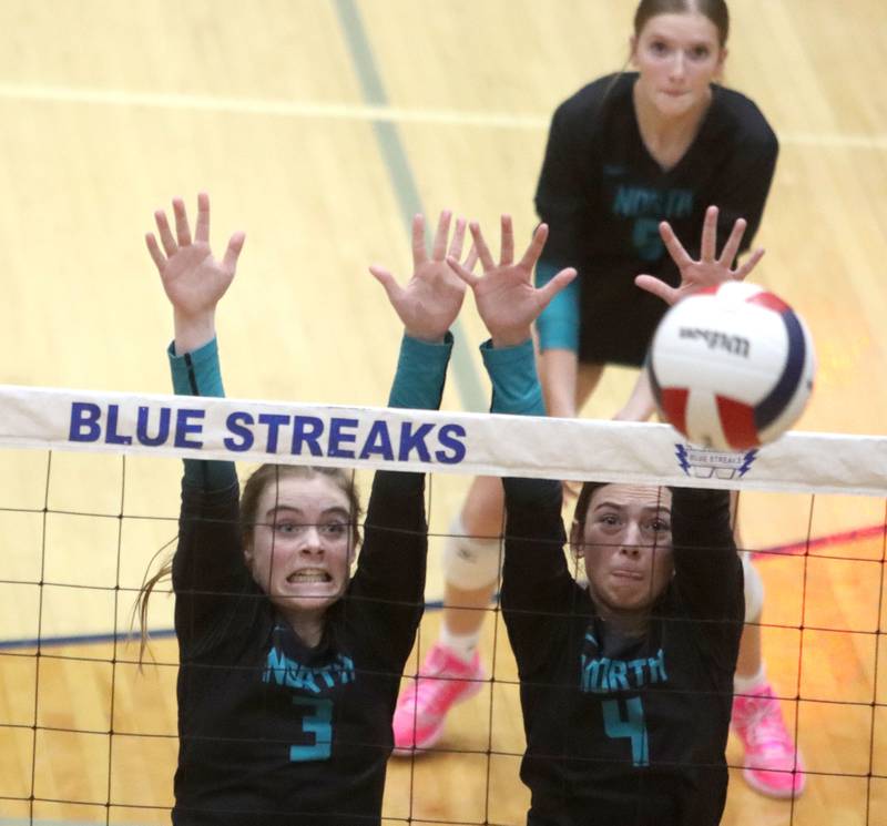 Woodstock North’s Adelyn Crabill, left, and Jenna Johnson block against Crystal Lake Central in IHSA girls volleyball Class 3A Regional action at Woodstock High School in Woodstock on Thursday, October 30, 2025.