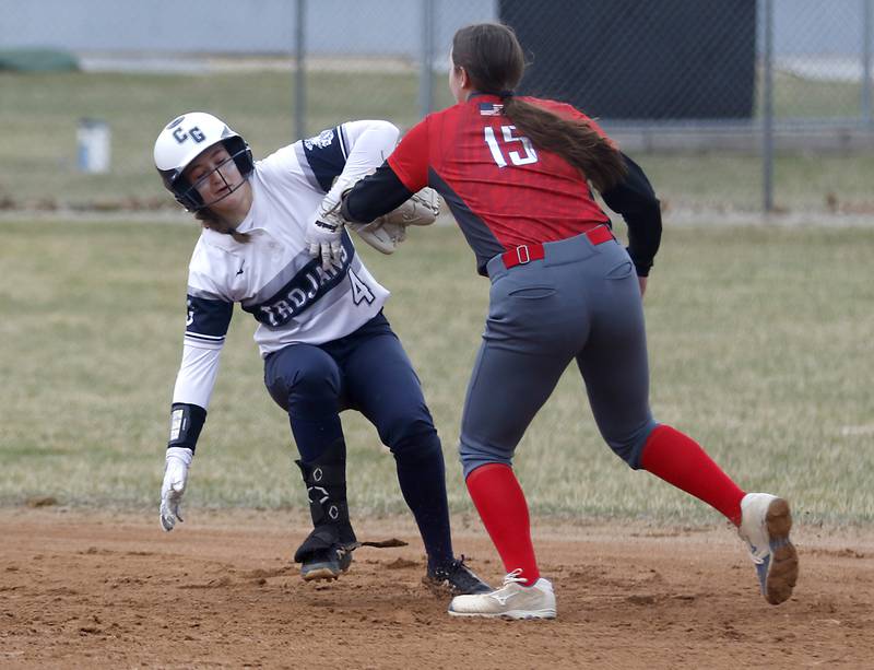 Dundee-Crown’s Reese Westland, right, tags out Cary-Groves Maddie Crick after she got caught in a run down during a Fox Valley Conference softball game Monday, April 4, 2022, between Cary-Grove and Dundee-Crown at Cary-Grove High School.