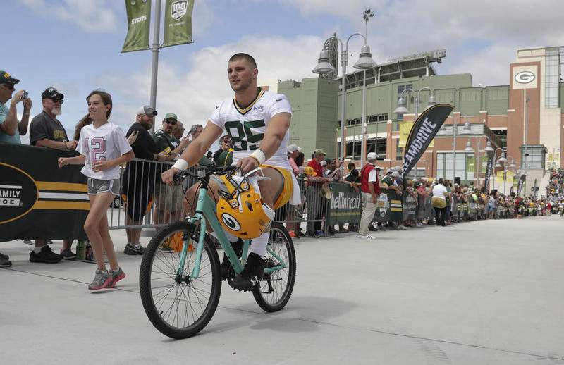 Green Bay Packers tight end Robert Tonyan rides a bike to training camp practice July 26 in Green Bay, Wis. The former McHenry quarterback is competing for a spot on Green Bay's roster.