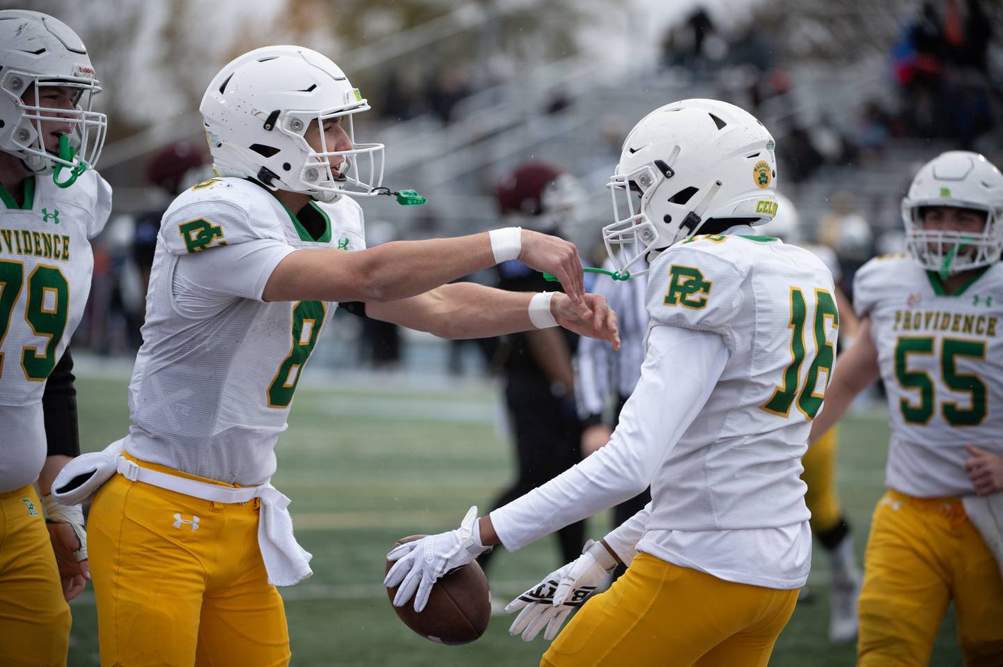 Providence Catholic's Dominic Vita, left, and DeAngelo Coates, right, celebrate his touchdown in the first half of a Class 5A playoff game against Kankakee on Saturday, November 8, 2025.