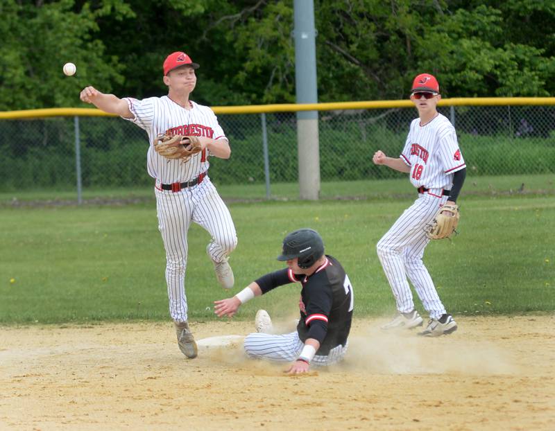 Forreston's Kendall Erdmann throws to first after forcing Fulton's Jacob Huisenga out at second during the 1A Amboy Regional on Saturday, May 24, 2025.