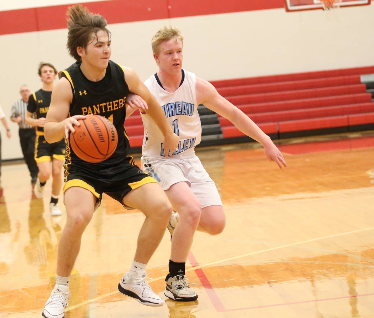 Putnam County's Owen Saepharn dribbles down the court as Bureau Valley's Bryce Helms defends during the 49th annual Colmone Class on Thursday, Dec. 7, 2023 at Hall High School.