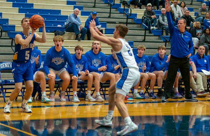 Wheaton North's Tony Janiak (5) spots up for a three-point shoot against Geneva’s Michael Lawrence (2) during a basketball game at Geneva High School on Friday, Jan 6, 2023.