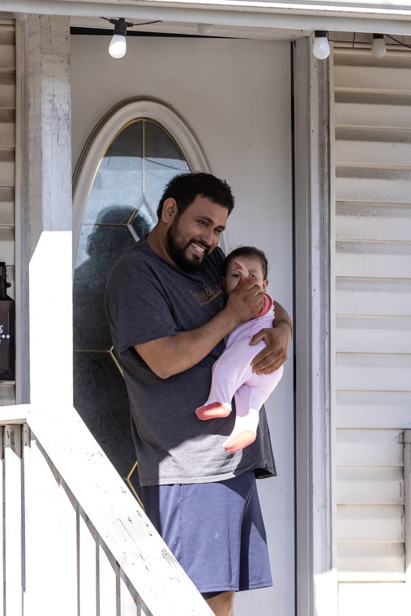 The Ballinas Family waves as the Joliet Central homecoming parade passes by their home on Sept. 27. 2025.